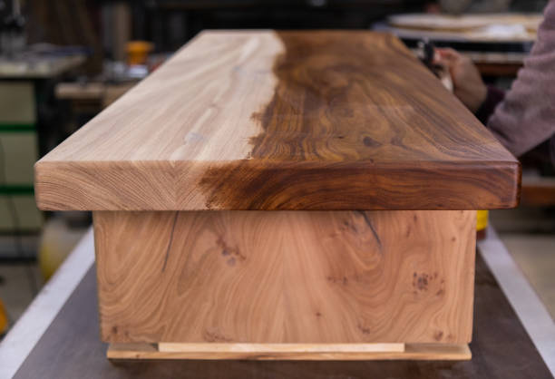 istock Half coated a wooden table with protective flaxseed oil in the workshop 1394648277