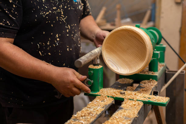 istock Carpenter preparing machine for turning wood on a lathe 1394650173