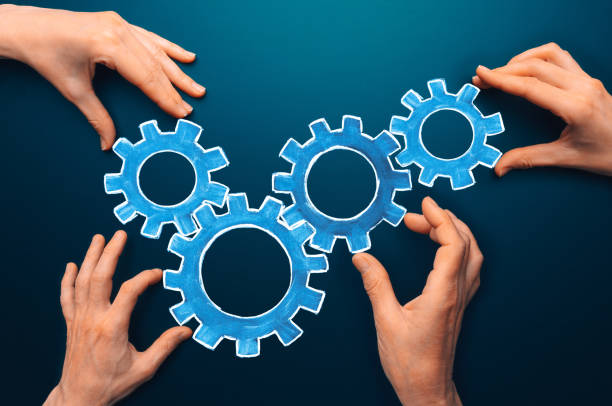 istock Teamwork concept. team connects gear parts. Idea of partnership, cooperation, team work. Metaphor for joining a partnership as diverse gears connected together as a corporate symbol for cooperation and working collaboration 1394651454