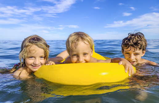 Three Smiling Children Having Fun at the Sea