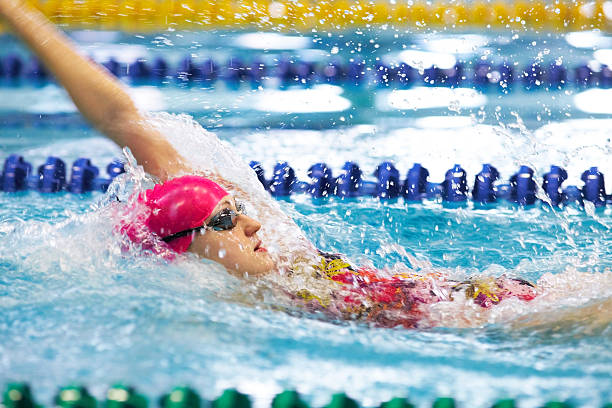 istock Young girl floating on her back in the pool 139465608