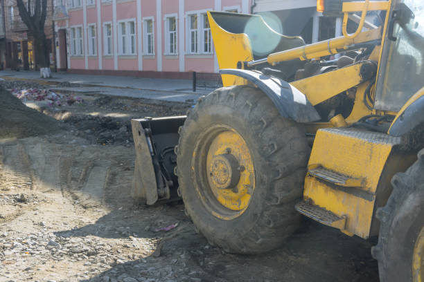 istock Heavy excavator excavating soil working during road works, moving gravel during construction of the new road 1394656264