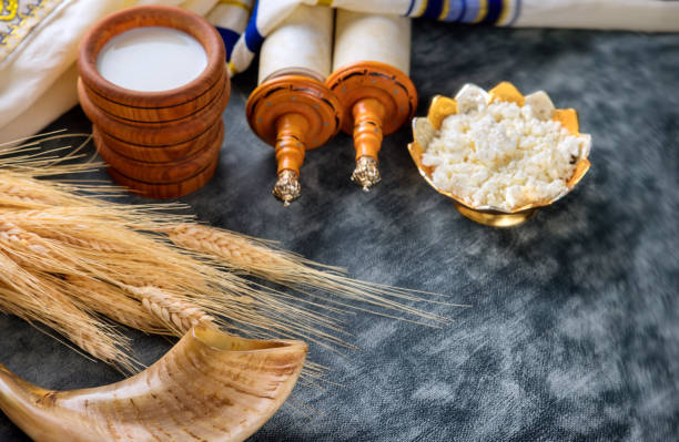 Jewish holiday Shavuot for kosher dairy food on torah scroll and tallis Jewish holiday Shavuot for kosher set dairy food on torah scroll and tallis simchat torah photos stock pictures, royalty-free photos & images