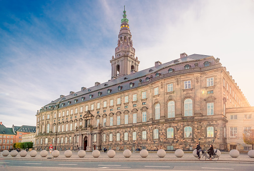 Christiansborg Palace with Christiansborg tower - the seat of the Danish Parliament in the rays of the setting sun. Copenhagen, Denmark