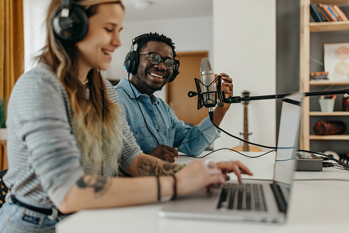 African American man and Caucasian Woman jointly hosting a podcast show