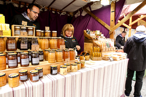 Finestrat, Alicante, Spain- April 23, 2022: Tasty jars of natural honey for sale at a market stall in Finestrat