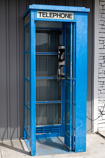 Obsolete run down telephone booth.