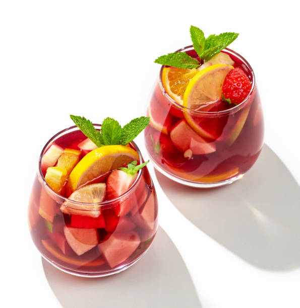 two glasses of red sangria two glasses of red sangria isolated on white background sangria stock pictures, royalty-free photos & images
