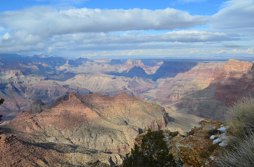Amazing views of the Grand Canyon on a sunny day with fluffy clouds.