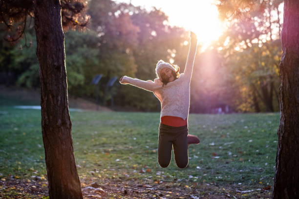 istock Happy girl jumping during sunset 1394663258