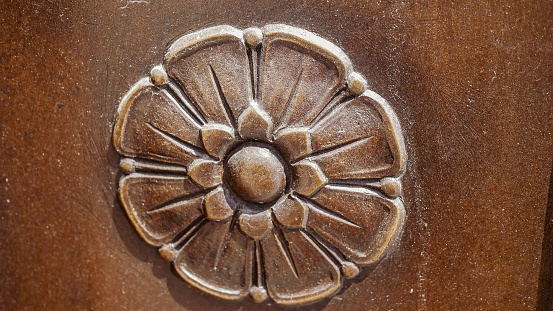 Macro shot of a vintage bronzed decor piece on the entrance to a building