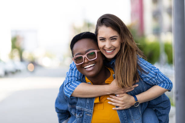 istock Interracial lesbian couple piggyback riding 1394666389