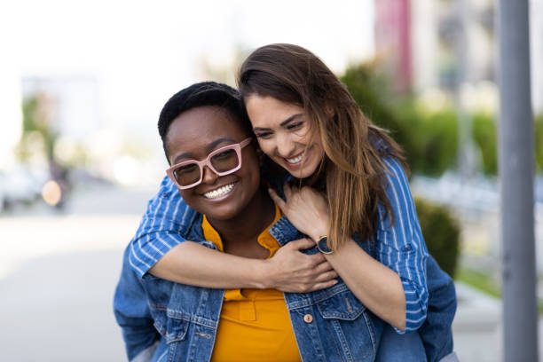 istock Interracial lesbian couple piggybacking 1394666391