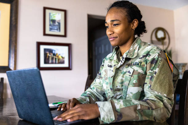 istock Young Black US Army Service member Using Laptop at Home 1394667361