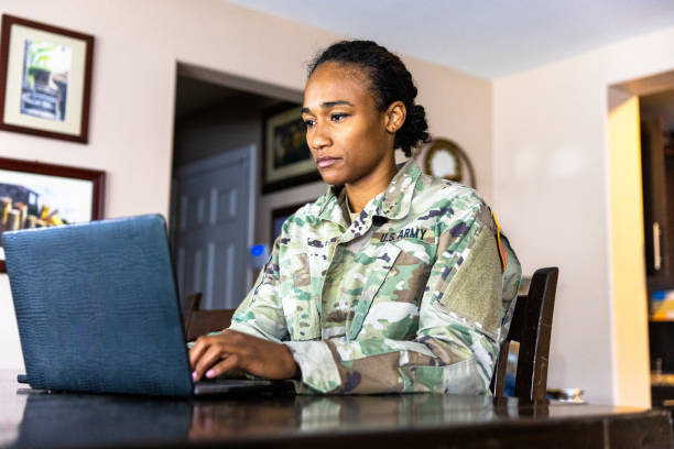 istock Young Black US Army Service member Using Laptop at Home 1394667365