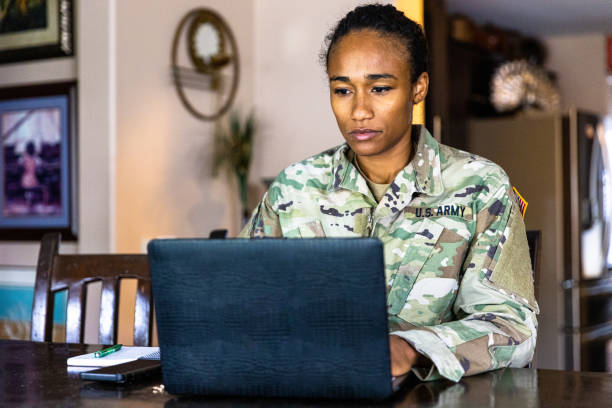 istock Young Black US Army Service member Using Laptop at Home 1394667366