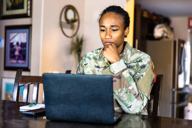 istock Young Black US Army Service member Using Laptop at Home 1394667368