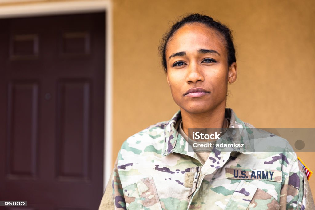 Young Black US Army Service Standing Outside A young black US Army Service member at home Veteran Stock Photo
