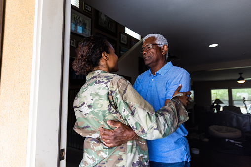 A father hugging his daughter who has returned home