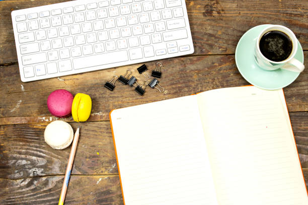 flat lay desktop, Modern computer keyboard and cup coffee and macarons and notebook or agenda for your text or design