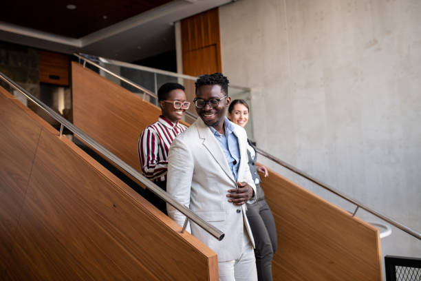 istock Young black businessman walking down the staircase in a hotel 1394669977