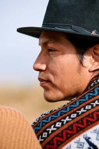 Portrait of serious Ecuadorian man in hat and in traditional clothing from his country outdoors.