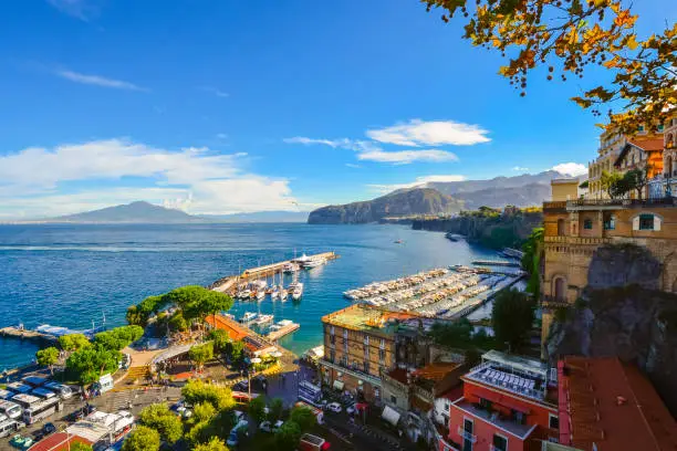 View of the Port and historic waterfront old town area of Sorrento, Italy, from a cliff viewpoint above the city and the Gulf of Naples on a sunny autumn day.