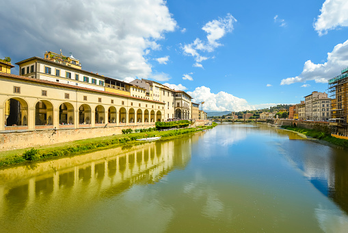 View of the Uffizi Gallery along the Arno River in the historic center of the Tuscan city of Florence, or Firenze Italy. Taken from the Ponte Vecchio Bridge.