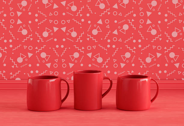 istock Solid red three coffee mugs side by side on monochrome red kitchen countertop front of red decorative wall, front view, 3d rendering, no people 1394673975
