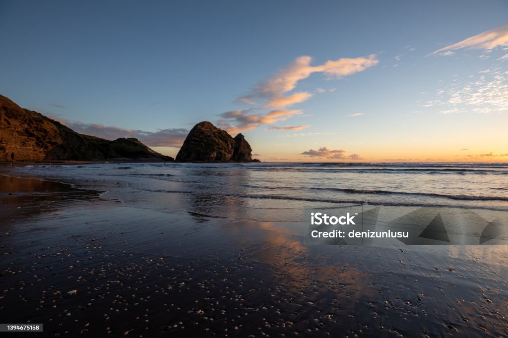 Piha Beach at sunset in Auckland, New Zealand Piha Beach Stock Photo