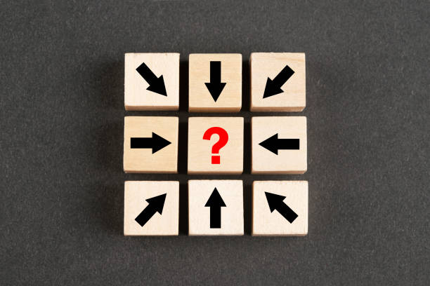 istock Wooden block cubes with arrows and question mark 1394676032