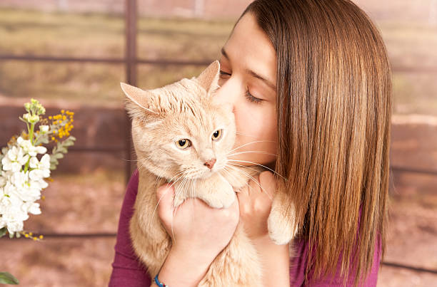 istock Young girl cuddling cute pet cat 139467626