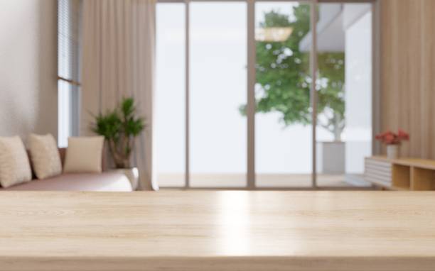 istock Empty wooden table top with sofa looking outdoor window. 1394681929