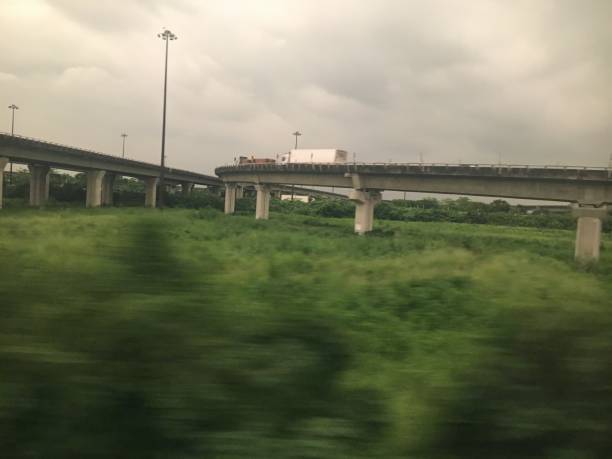 expressway through green fields and rainy weather