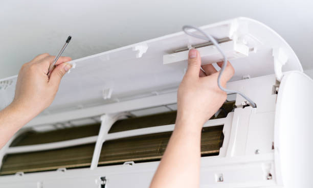 istock Male technician fixing air conditioner indoors 1394688825