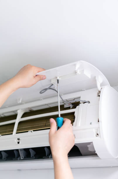 istock Male technician fixing air conditioner indoors 1394688826