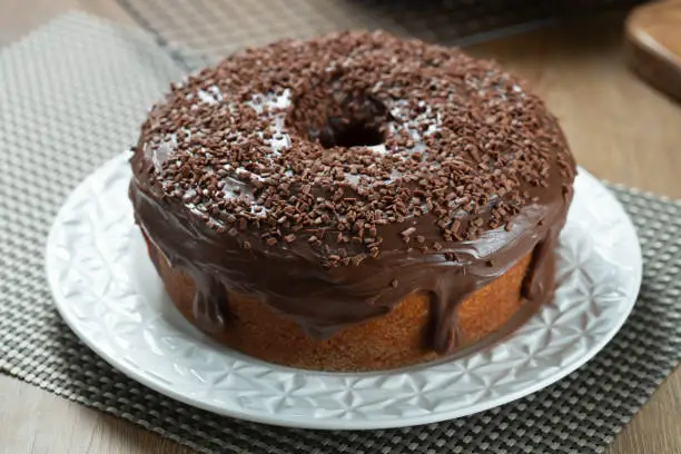 Chocolate cake on wooden table with chocolate sprinkles. Brigadeiro. Typical Brazilian sweet