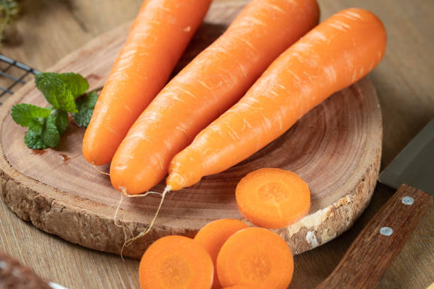 istock Fresh carrots and mint on a wooden table 1394690593