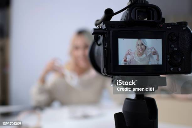 Asian Female Blogger Or Vlogger Looking At Camera Reviewing Product Stock Photo - Download Image Now