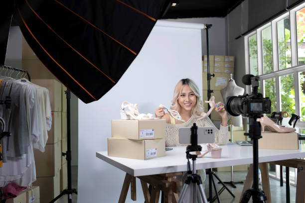 istock Asian female blogger or vlogger looking at camera reviewing product. 1394701310