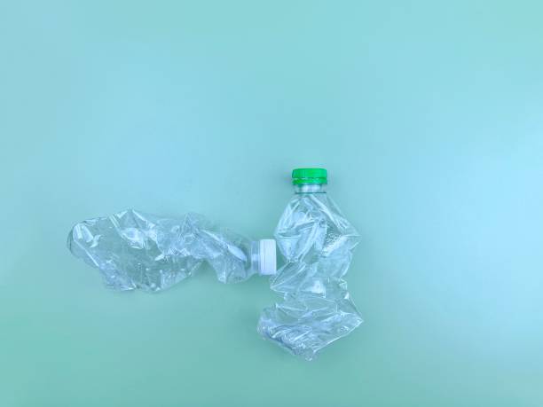istock Eco-friendly degradable clear plastic bottle placed on a gradient reflections green blue background. 1394707536