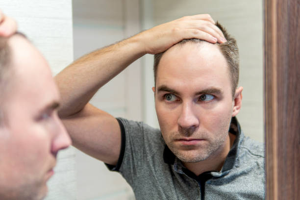 istock Portrait of a man looking in mirror 1394710742