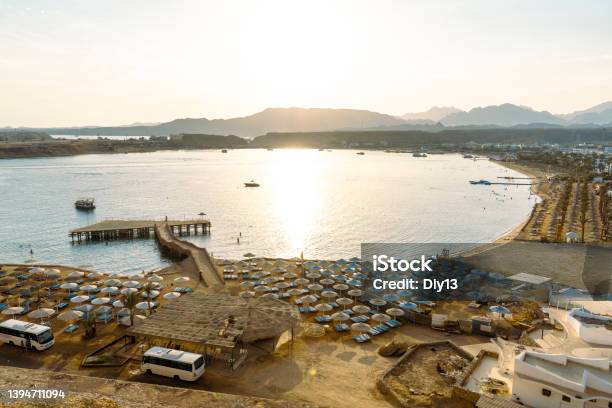 Sharm El Sheikh City Landscape Sea Sandy Beach Against The Background Of Mountains And Sunset Stock Photo - Download Image Now