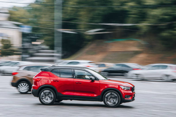 Red Volvo XC40 car moving on the street. Ukraine, Kyiv - 2 August 2021: Red Volvo XC40 car moving on the street. Editorial volvo photos stock pictures, royalty-free photos & images