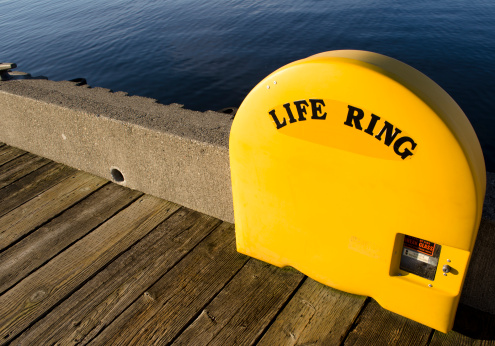 Life Ring, marine safety equipment, on dock in marina.