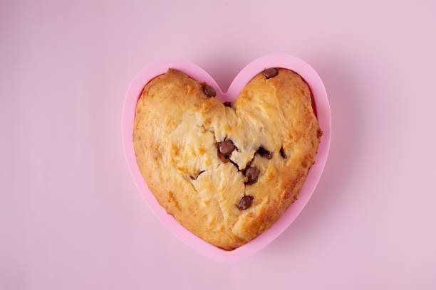 istock heart shaped cupcake with chocolate pieces on pink background, close-up 1394722647