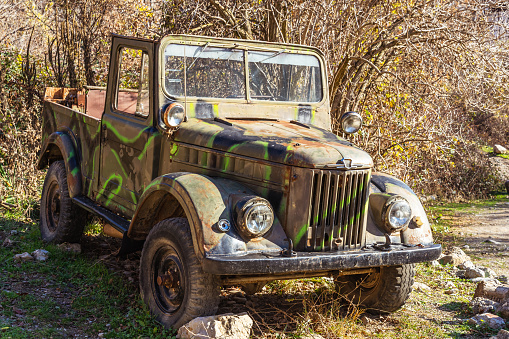 The widely known ancient Russian all-terrain vehicle GAZ-69 abandoned in the forest. This type of car was produced from 1952 to 1972.