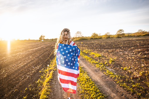 Woman with American flag in nature
