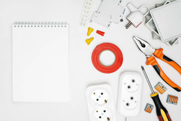 istock white blank space, notebook and electrical tools and equipment, top view. 1394730386
