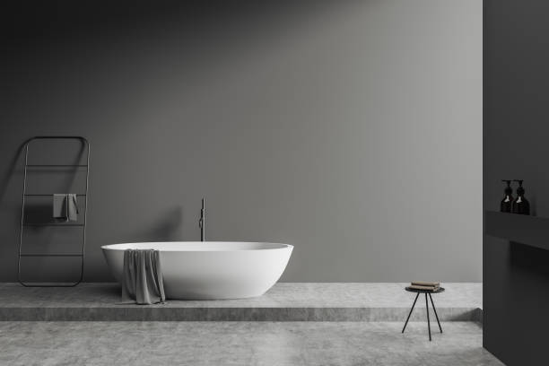 istock Grey bathroom interior with tub, rail ladder and table. Mockup 1394730676